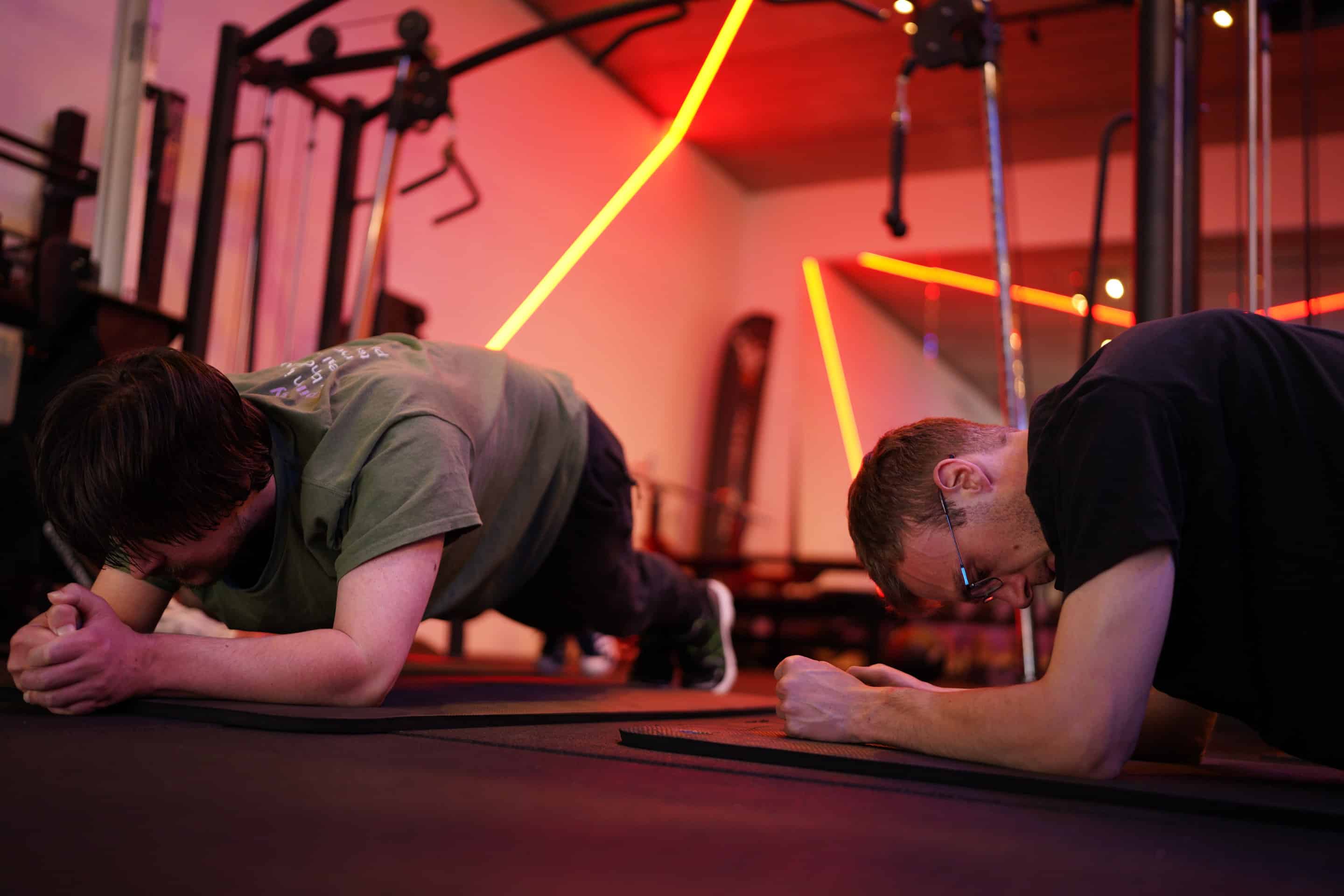 Twee mannen doen een plank op hun onderarmen
